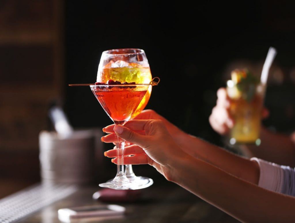 toasting with cocktails in bar 1024x773