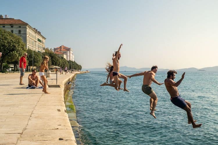 Jumping into sea harbour Zadar Croatia