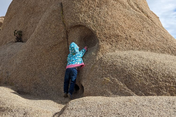 child on boulder at discovery trail