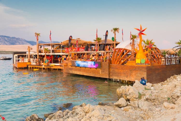 Crowd of young people partying on a hot summer day on Zrce beach Novalja Pag island Croatia